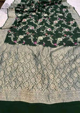 Georgette khaddi saree in bottle green colour. Saree has a delicate water zari border with Gorgeous unique Motifs near pallu. The entire saree is beautiful with water zari meenakari design. It is an elegant traditional Banarasi saree. Irresistible wedding collection. This Mesmerising Saree is a Combination of Elegance and Style