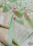 Georgette khaddi saree in light pista colour. Saree has a delicate water zari border with Gorgeous unique Motifs near pallu. The entire saree is beautiful with water zari meenakari design. It is an elegant traditional Banarasi saree. Irresistible wedding collection. This Mesmerising Saree is a Combination of Elegance and Style