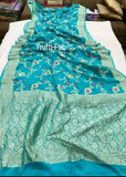 Georgette khaddi saree in firozi colour. Saree has a delicate water zari border with Gorgeous unique Motifs near pallu. The entire saree is beautiful with water zari meenakari design. It is an elegant traditional Banarasi saree. Irresistible wedding collection. This Mesmerising Saree is a Combination of Elegance and Style.