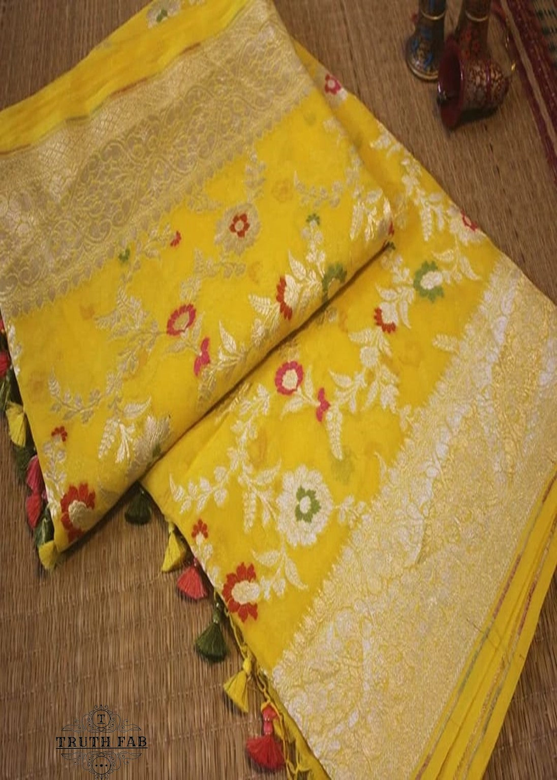 Georgette khaddi saree in sun flower yellow colour. Saree has a delicate water zari border with Gorgeous unique Motifs near pallu. The entire saree is beautiful with water zari meenakari design. It is an elegant traditional Banarasi saree. Irresistible wedding collection. This Mesmerising Saree is a Combination of Elegance and Style.