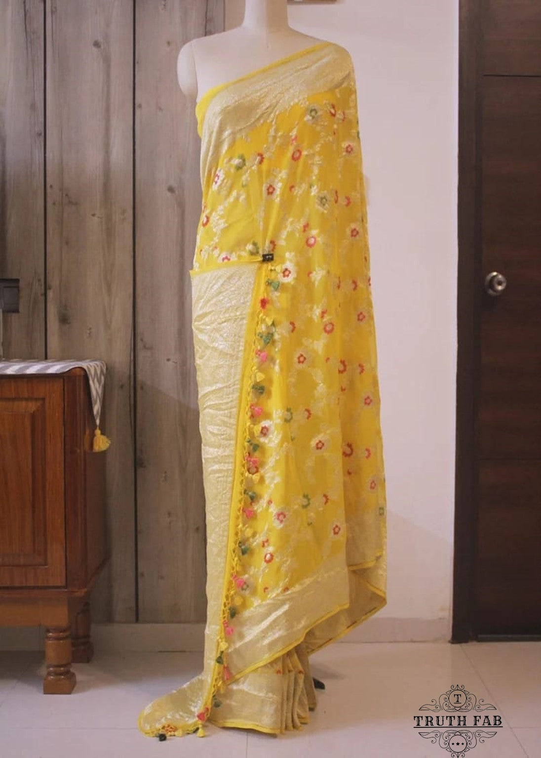 Georgette khaddi saree in sun flower yellow colour. Saree has a delicate water zari border with Gorgeous unique Motifs near pallu. The entire saree is beautiful with water zari meenakari design. It is an elegant traditional Banarasi saree. Irresistible wedding collection. This Mesmerising Saree is a Combination of Elegance and Style.